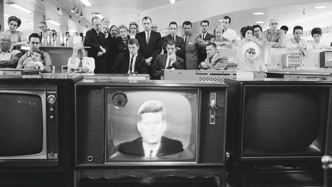 Customers in the electronics section of a department store watch as JFK addresses the nation, 22 October 1962