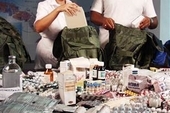 Although it is unlikely they will be going anywhere, Havana doctors Luis Sauchay and Delvis Marta Fernandez prepare their knapsacks of emergency medical supplies for Katrina victims.