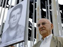 Giustino holds a photograph of his son Fabio at a vigil for justice for victims of terrorism in Havana