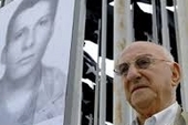 Giustino holds a photograph of his son Fabio at a vigil for justice for victims of terrorism in Havana
