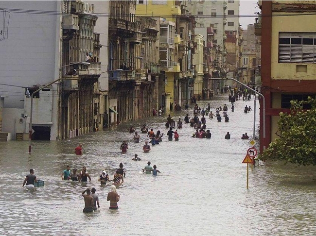 People move through flooded streets in Havana after the passage of Hurricane Irma, in Cuba, Sunday, Sept. 10, 2017