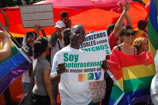 A participant in the 2016 IDAHO march with a banner which reads 'I'm heterosexual, my best friend is gay'