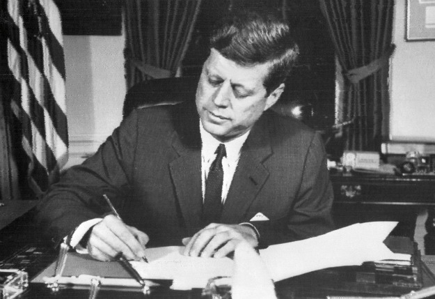 President John F. Kennedy signing ‘Proclamation 3447 – Embargo on All Trade with Cuba’ on 3 February 1962 