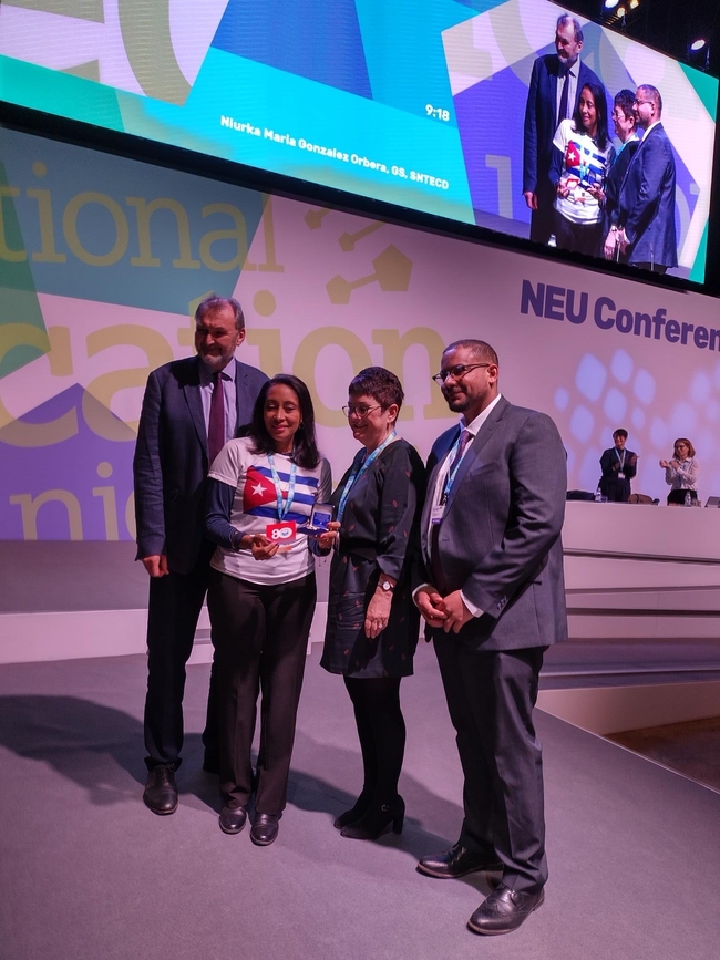 NEU joint general secretaries, Mary Bousted and Kevin Courtney, with president Daniel Kebede receiving the CTC 80th anniversary medal