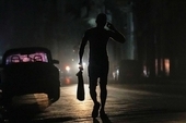 A Cuban walks on a street during a general blackout in Havana, March 14 2025