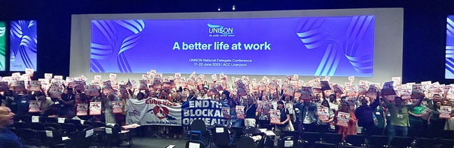 of UNISON delegates, including General Secretary Christina McAnea holding up Cuba Vive, End the Blockade on Health posters