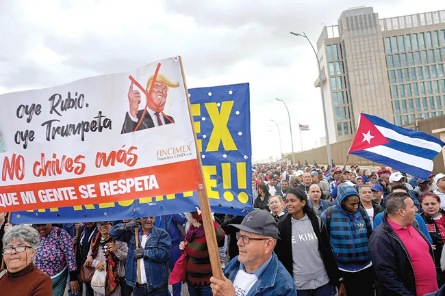 Cubans file past the US Embassy on January 16 holding a banner: ‘Listen Rubio, listen Trumpeta (Loudmouth) stop hussling us, our people will be respected’ Cubans file past the US Embassy on January 16 holding a banner: ‘Listen Rubio, listen Trumpeta (Loudmouth) stop hussling us, our people will be respected’